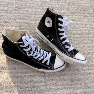 Black high-top converse Chuck Taylor’s